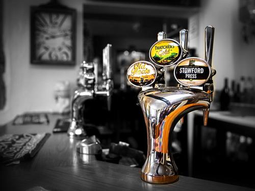 a bar with a chrome faucet on a counter at The White Bear in Shipston on Stour