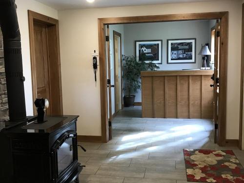 a living room with a door leading to a hallway at Wildflowers Country Inn in Rocky Harbour