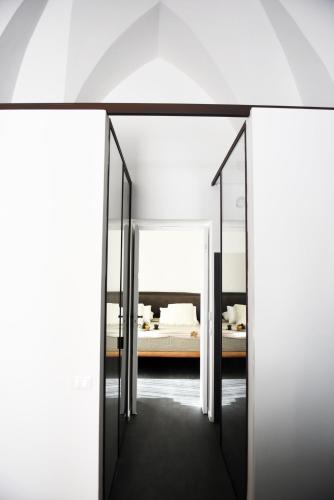 a room with two mirrors and a bed at Arya Nobile Dimora in Carovigno