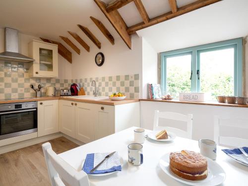 a kitchen with a table with a cake on it at Woodcock Farm in Bristol