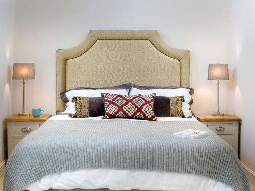 a large bed with two lamps on two night stands at Woodcock Farm in Bristol