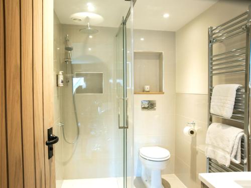 a bathroom with a shower and a toilet at Woolmarket House in Chipping Campden