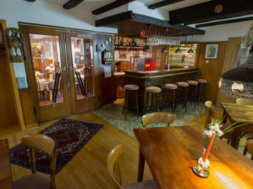 un bar con tavolo e sedie in un ristorante di Hotel zur Post - Burg an der Mosel a Burg (an der Mosel)