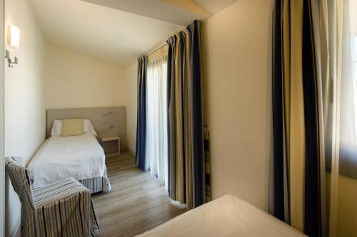 Ένα ή περισσότερα κρεβάτια σε δωμάτιο στο Hotel Arena
