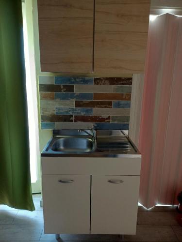 a kitchen with a sink and a brick wall at Sole&Scudo in Venaria Reale