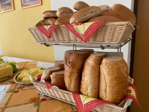 a pile of loaves of bread in baskets on a table at Ośrodek Gwiazda Morza in Grzybowo