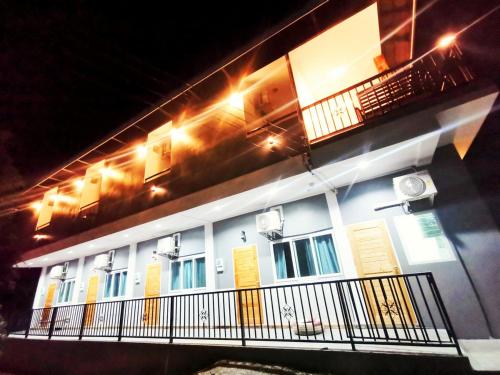 a building with a balcony with lights on it at ลิตเติ้ล ฮิลล์ สัตหีบ รีสอร์ท ( Little Hill Sattahip Resort ) in Sattahip