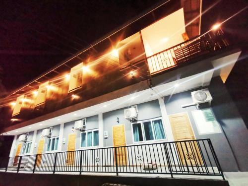a building with a balcony and lights on it at ลิตเติ้ล ฮิลล์ สัตหีบ รีสอร์ท ( Little Hill Sattahip Resort ) in Sattahip
