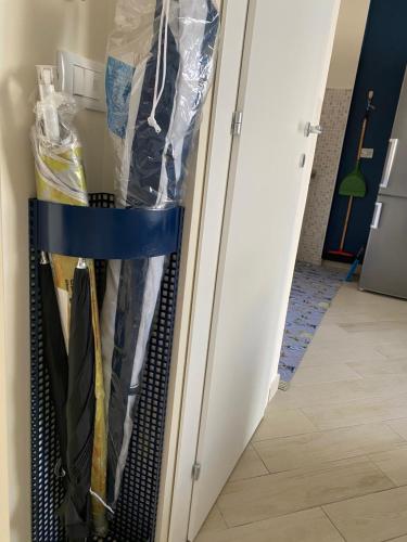 a closet with a door full of clothes at Casa vacanze Auletta in Capo dʼOrlando
