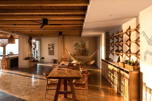 a living room with wooden ceilings and a table and chairs at Andronis Arcadia Hotel in Oia