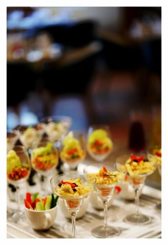 a group of wine glasses filled with food on a table at Best Western Plus Tejvivaan in Visakhapatnam