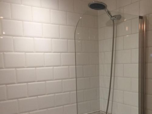 a shower with a shower head in a bathroom at The Clacks Rustic Abode in Tillicoultry