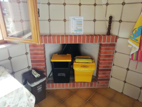 a brick fireplace with two trash cans in it at Appartamento da Valentino in S'archittu Cuglieri