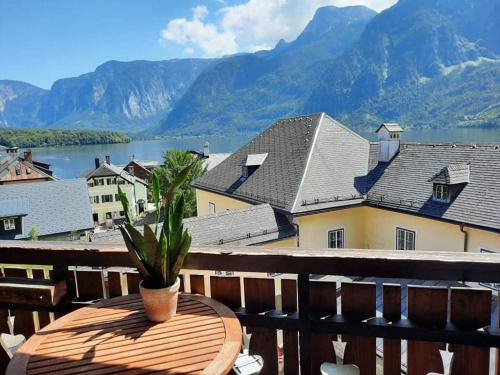 a table on a balcony with a view of the mountains at Pension Leopoldine in Hallstatt