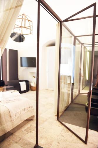 a bedroom with a large mirror in a room at Arya Nobile Dimora in Carovigno
