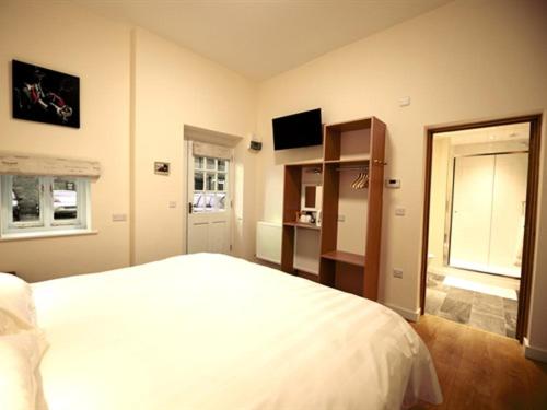 a bedroom with a white bed and a window at THE COACHING BARNS in Shrewsbury