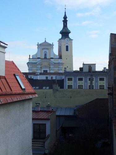 a large building with a clock tower on top of it at Penzion Menšík in Kroměříž