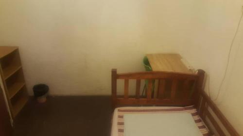 a corner of a room with a chair and a desk at Cocoa Mews Cafe and Homestay in George Town