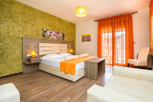a hotel room with a bed and a couch at Garden in Limenaria