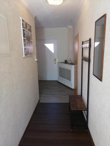 a hallway with a stairway and a room with a table at Müritzblick am Wünnow in Röbel