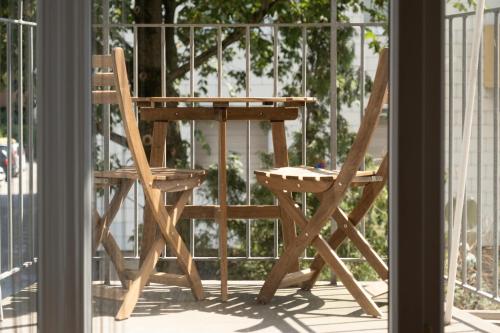 a wooden chair sitting next to a table on a porch at MH Living - 5 - Scandinavian Living Dream in Center in Graz