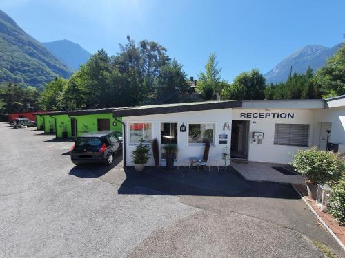 a car parked in front of a building at Motel - Hôtel "Inter-Alp" à St-Maurice in Saint-Maurice