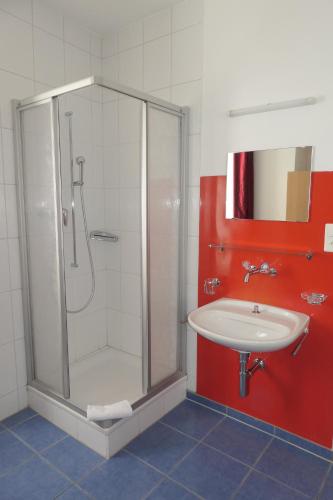 a bathroom with a shower and a sink at Hotel Franziskaner in Chur
