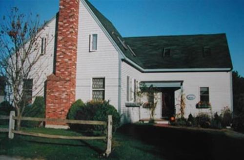 a white house with a red brick chimney at Gardenview Bed and Breakfast in Newport