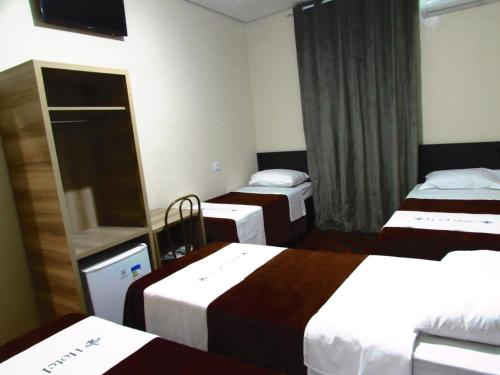 Postel nebo postele na pokoji v ubytování Hotel Minho - Próximo 25 de Março Brás e Bom Retiro e Hospital Pérola Byington "Garanta já a sua Reserva"
