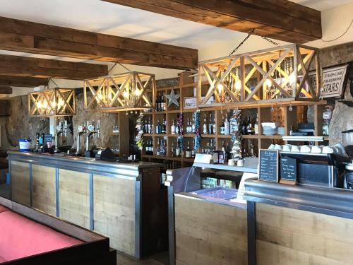 a bar with a lot of bottles of alcohol at The Grotto in South Shields