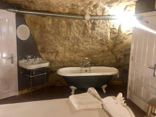 a bathroom with a bath tub and a sink at The Grotto in South Shields
