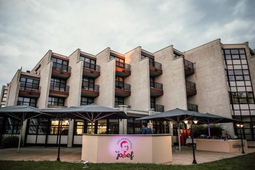 a large building with umbrellas in front of it at Parkhotel Brunauer in Salzburg