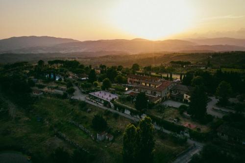 an aerial view of a town with mountains in the background at Fattoria Degli Usignoli in San Donato in Fronzano