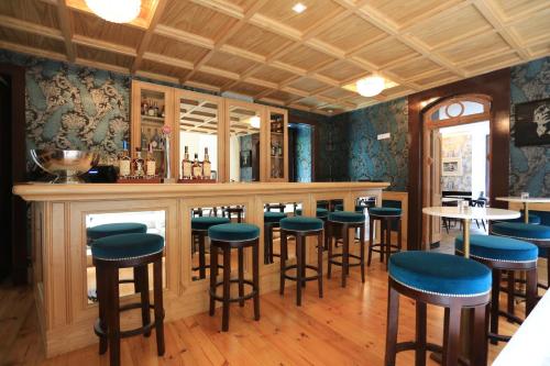 a bar in a restaurant with blue stools at Santiago de Alfama - Boutique Hotel in Lisbon