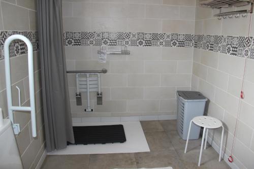 a bathroom with a shower and a stool in it at Casa Robion in Godelleta