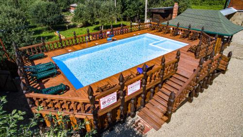 an overhead view of a pool with a wooden deck and a swimming poolvisor at Barskaya Usadba in Kamennomostskiy