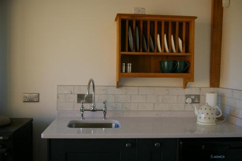 a kitchen counter with a sink and a cabinet at Horizon Barn in Market Rasen
