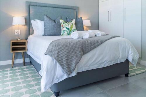 ein Schlafzimmer mit einem großen Bett mit zwei Handtüchern darauf in der Unterkunft Waterfront Getaway, 2 Bedroom Seaside Bliss in Umdloti