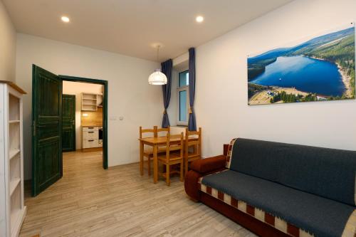 a living room with a couch and a table at Apartmány pod Mariánskými schody in Albrechtice v Jizerských horách