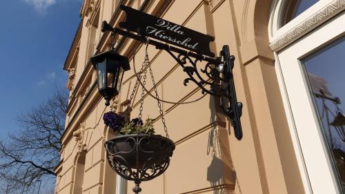 a hanging planter on the side of a building at Villa Hierschel Droyßig in Droyßig