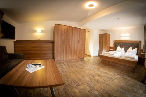a living room with a couch and a bed at der Steinerwirt in Wagrain