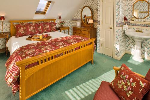 a bedroom with a large bed and a sink in it at Inn at Jackson in Jackson