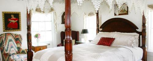 a bedroom with a large bed with a canopy at The Inn at Stony Creek in Warwick