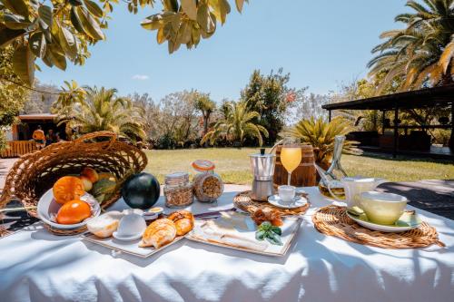 a table with a breakfast of fruit and juice at Agroturismo Can Pere Sord in Sant Joan de Labritja