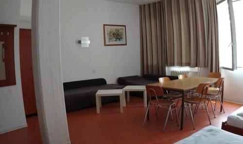 a living room with a table and a couch at Hostel am Kurtti in Berlin