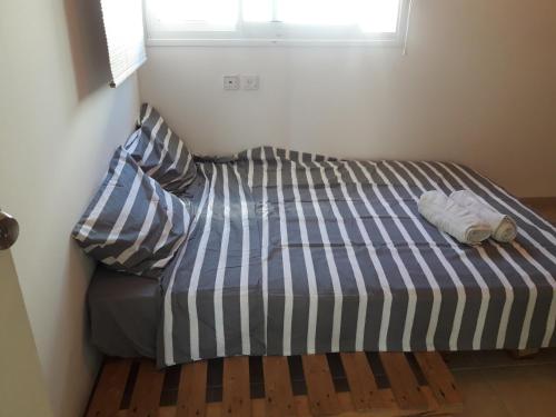 a bed with two pillows on it in a room at Oren's place - perfect for families & friend's in Kefar Weradim