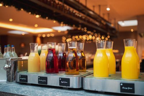 a row of different types of drinks on a counter at Crowne Plaza Gerrards Cross by IHG in Beaconsfield