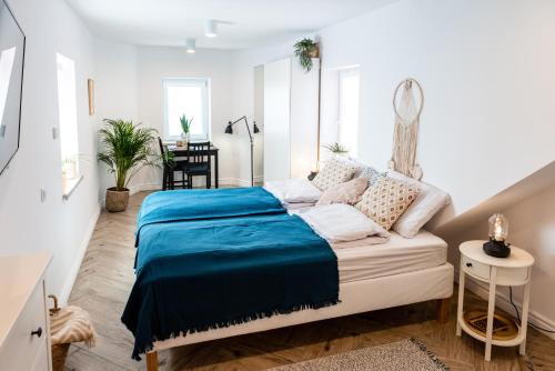 a bedroom with a bed with a blue blanket at BOHO HOUSE in Ustrzyki Dolne