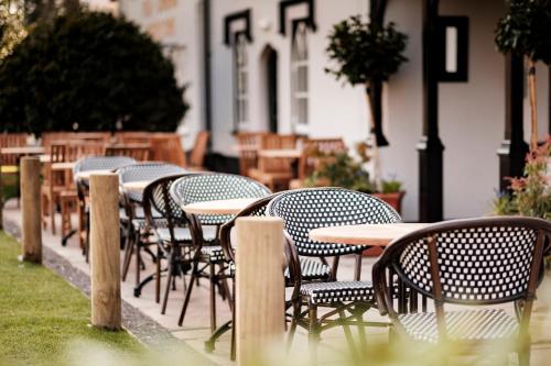a row of tables and chairs outside of a restaurant at Bear Of Burton in Christchurch