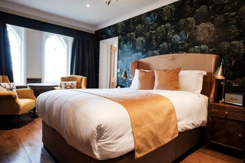 a bedroom with a large bed and a wall mural at Bear Of Burton in Christchurch